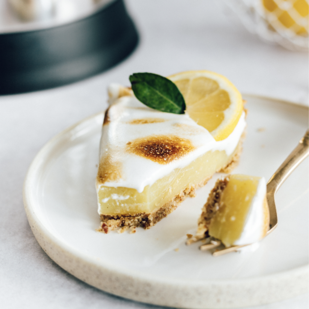 Vegan, gluten-free lemon meringue tart on a plate.