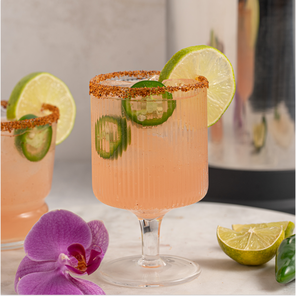 Spicy Watermelon Paloma with lime and jalapeno slices in glass