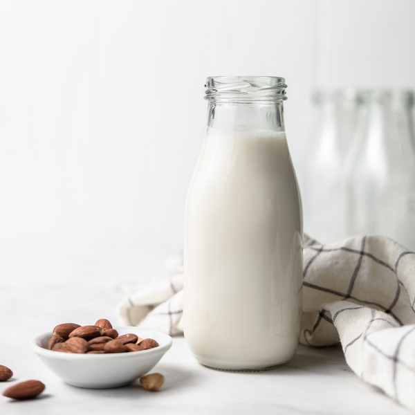 plant-based almond creamer in an almond cow glass bottle 