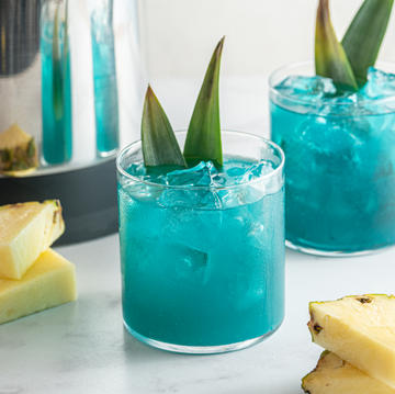 Blue Hawaiian Cocktail made with pineapple, coconut shreds, and rum.