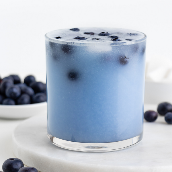 plant-based blueberry coconut cooler in a glass with blueberries