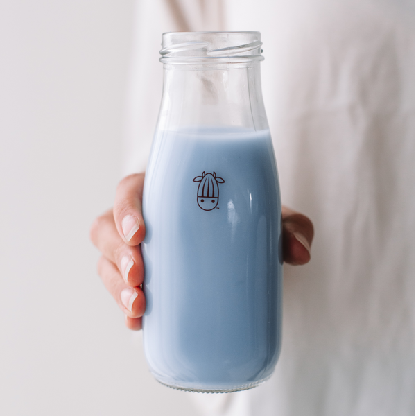vegan blue bubblegum milk in a glass bottle