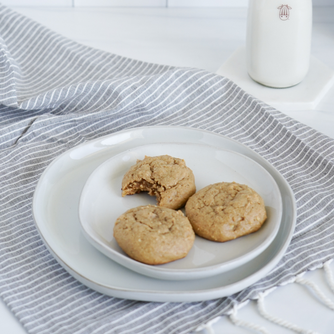 vegan cashew butter cookies with a glass of plant-based milk
