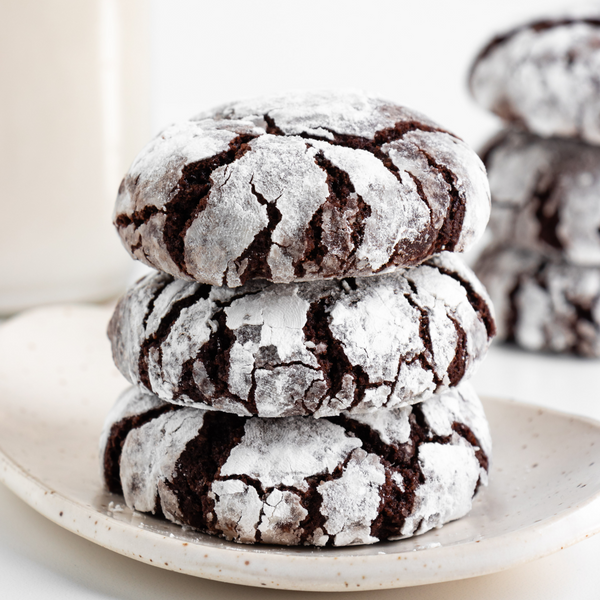 Stack of vegan Chocolate Cashew Crinkle Cookies on a plate