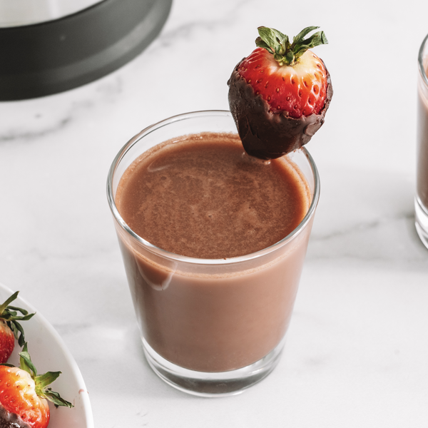 glass of plant-based chocolate covered strawberry milk