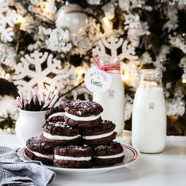 vegan chocolate peppermint sandwich cookies on a plate with a glass of plant-based milk