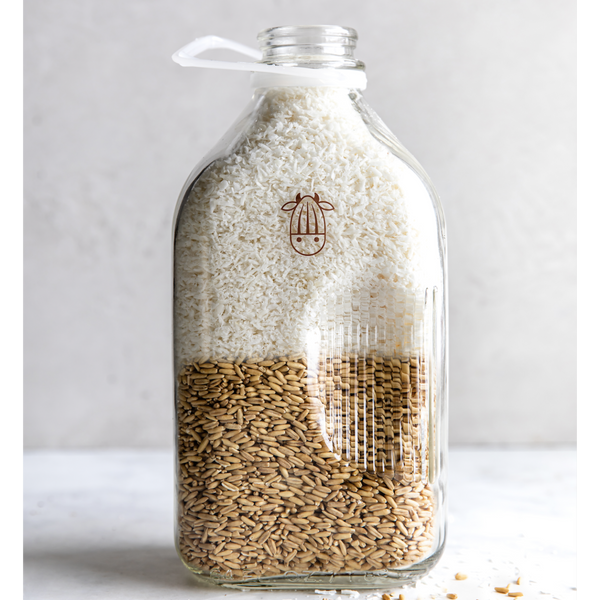 almond cow milk jug with half whole grain oats and half coconut shreds