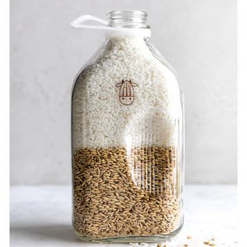 almond cow milk jug with half whole grain oats and half coconut shreds