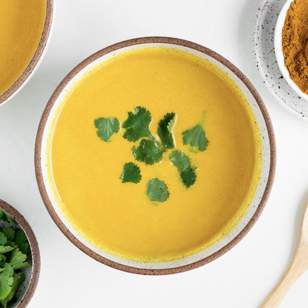 vegan coconut curry soup in a bowl garnished with cilantro