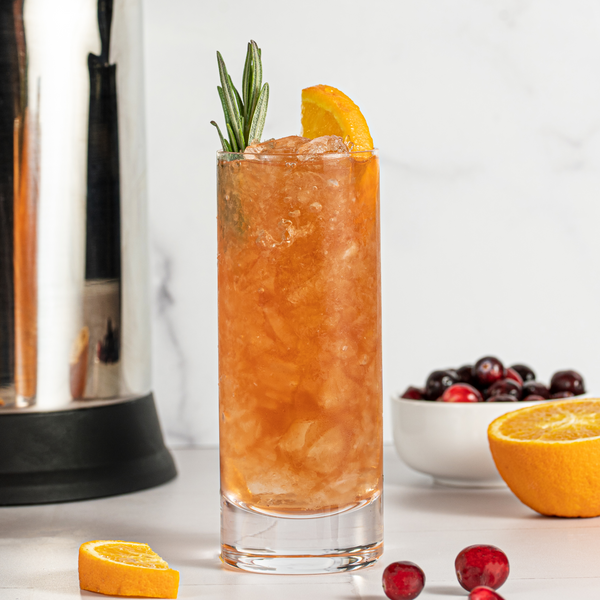 Cranberry Sherry Cobbler in a glass garnished with rosemary and orange slice