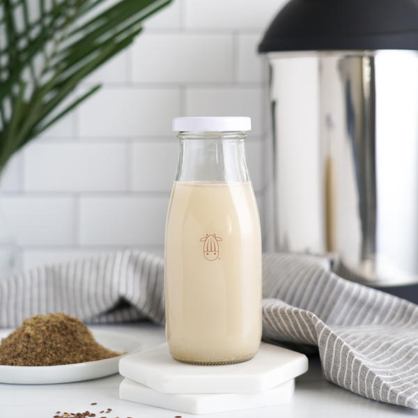 flax milk in a almond cow glass milk bottle