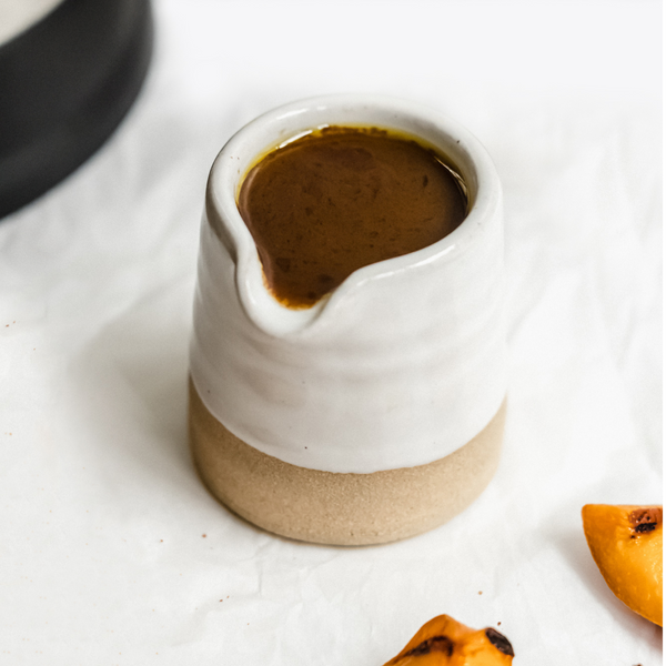 Grilled Peach Balsamic Reduction in a ceramic pitcher