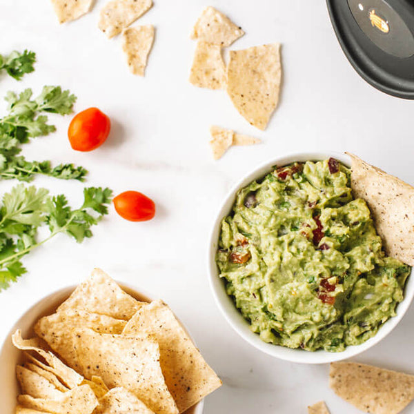 A bowl of guacamole and chips