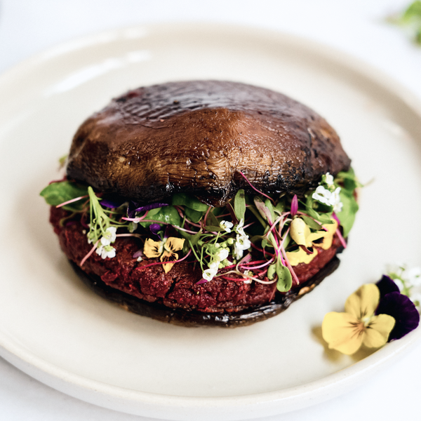 Herb Garden Plant Pulp Patty burger on a plate with edible flowers