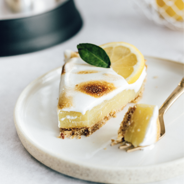 Vegan, gluten-free lemon meringue tart on a plate. 
