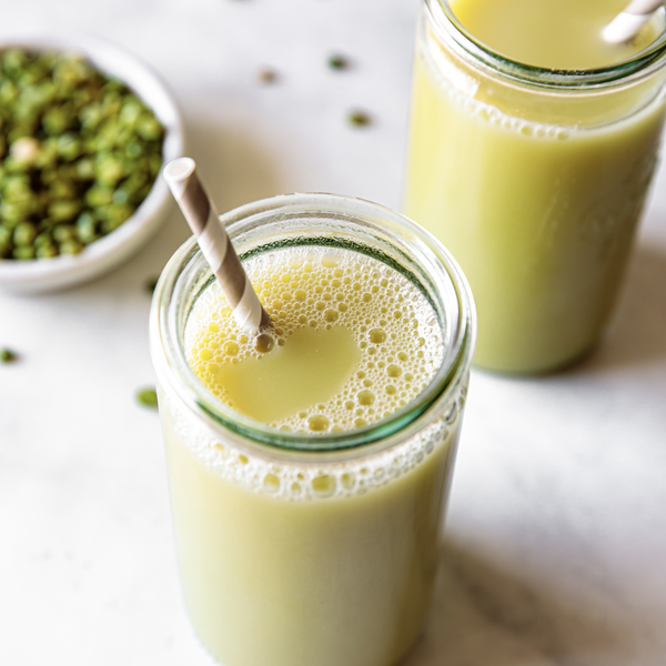 vegan homemade Pea Milk in a glass with a straw