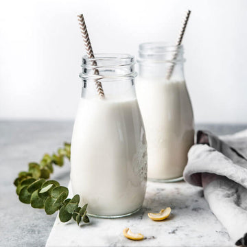 jugs of coconut cashew milk made with the almond cow pro