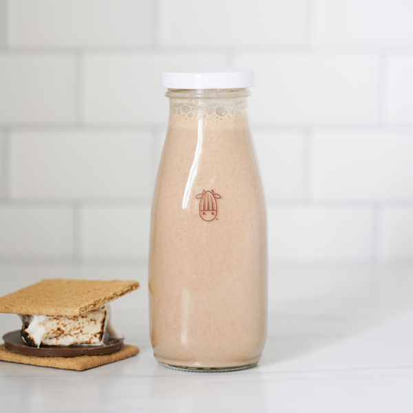 plant-based s'mores creamer in an almond cow glass bottle
