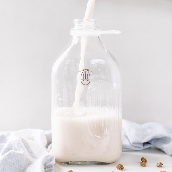 Tiger Nut Milk being poured into an almond cow jug