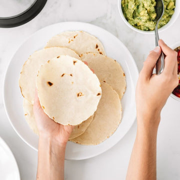 A plate of homemade tortillas and a side of guacamole