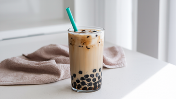 a boba tea with a green straw, made with your Almond Cow