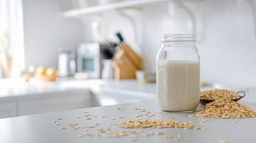 A glass of plant-based oat milk, freshly made using an Almond Cow milk making machine. 