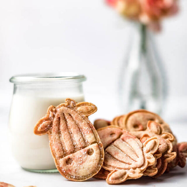 vegan Almond Cow Cookies with a glass of plant-based milk