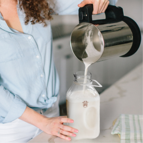 Pour milk from Milk Maker machine into the glass jug